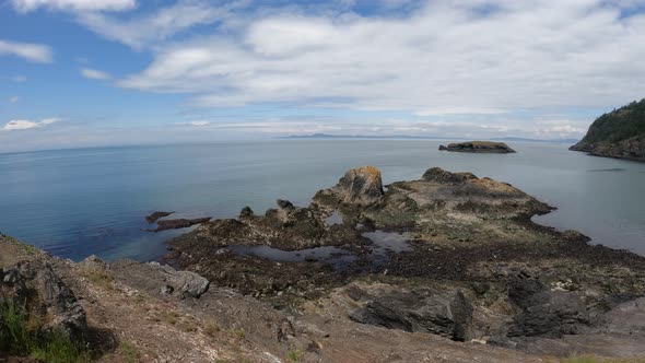 Panning wide shot of Rosario Beach and its numerous tide pools on Fidalgo Island.