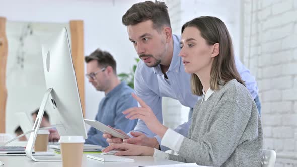 Hardworking Creative Team Working on Desktop in Office