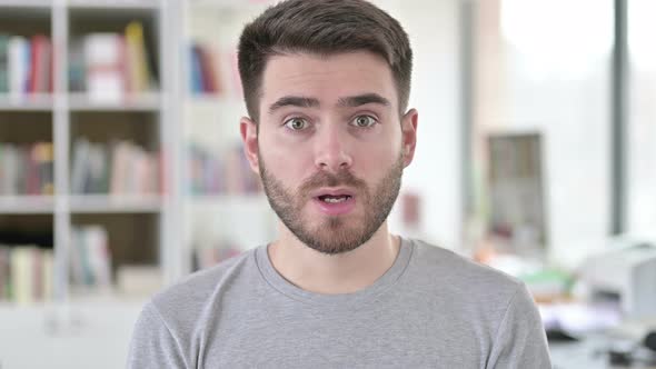 Portrait of Angry Young Man Shouting, Screaming