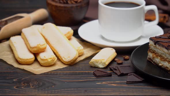 Portion of Traditional Italian Tiramisu Dessert Cup of Espresso and Savoiardi Cookies