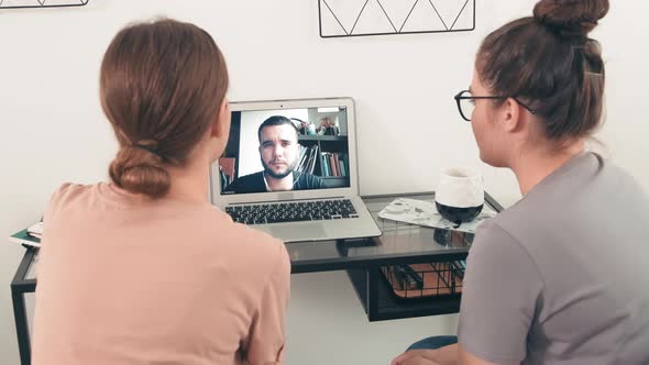 Young Women Talking on Video Call with Man