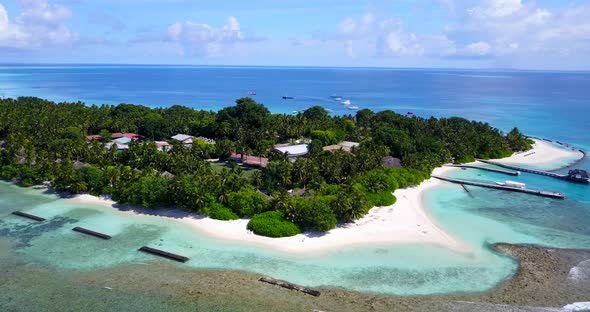 Wide overhead abstract shot of a white sand paradise beach and aqua blue ocean background in colorfu