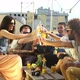 Cheerful multi-ethnic friends laughing and toasting with cocktails at rooftop - VideoHive Item for Sale