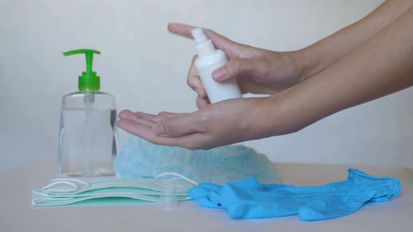 Close Up Of Woman Hand Splashing From Bottle Of Alcohol Solution On Her Hands