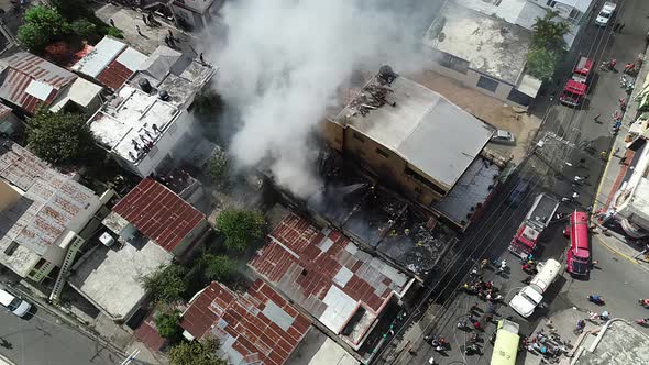 Aerial view of a building fire, a massive smoke cloud rising from the flaming structure, in Brazil -