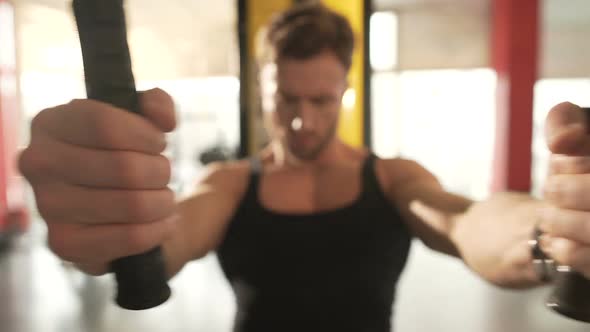 Male With Highly Developed Muscles Doing Chest Fly Workout at Fast Pace in Gym