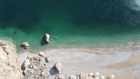 Aerial View From Above on Azure Sea and Pink Pebbles Beach