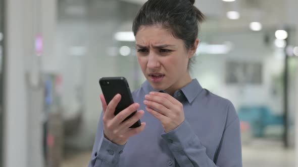 Portrait of Young Indian Woman Loss on Smartphone