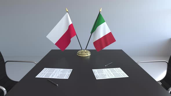 Flags of Poland and Italy and Papers on the Table alt