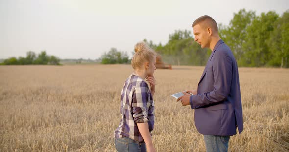 Agriculture - Farmer Talking with Businessman at Harvesting