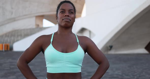 Fit african girl laughing in the city after sport workout