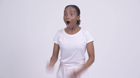 Young African Woman Looking Shocked and Stunned