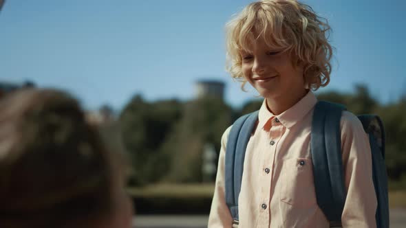 Schoolboy Giving High Five to Mom Before Studies Close Up