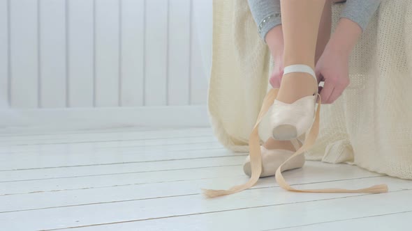 Ballerina Puts on Pointe Shoes on Her Feet