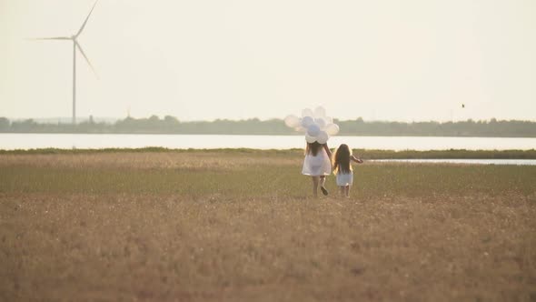 Mother with Daughter and White Balloons