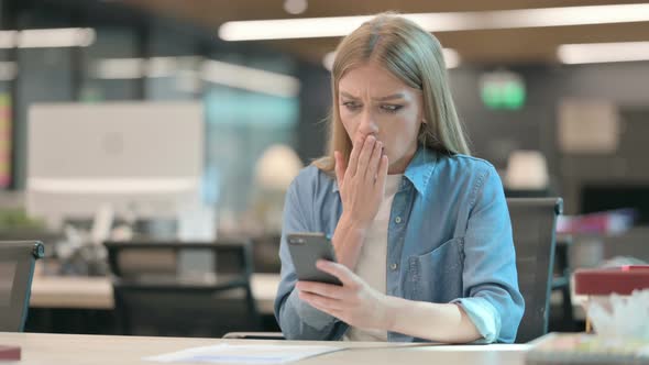 Upset Young Woman Reacting to Loss on Smartphone