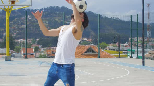 Handsome man practicing soccer tricks