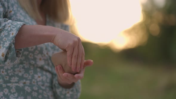 Women's Hands Closeup Sculpt an Object From Clay in Nature Outdoors in the Park in the Evening at