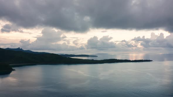 Scenic View Of Gray Stormy Clouds Over The Calm Ocean At The Naviti Island In Fiji - slow tilt down