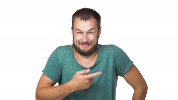 Headshot Portrait of Bearded Cheerful Man 30s Wearing Shirt Laughing at Someone Pointing Finger