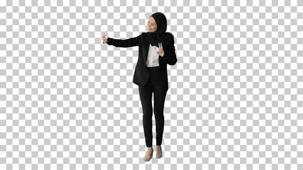 Smiling Arab woman in hijab taking selfies, Alpha Channel