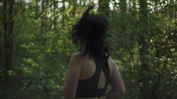 Slow Motion Video of a Girl Jogging in the Park at Sunset