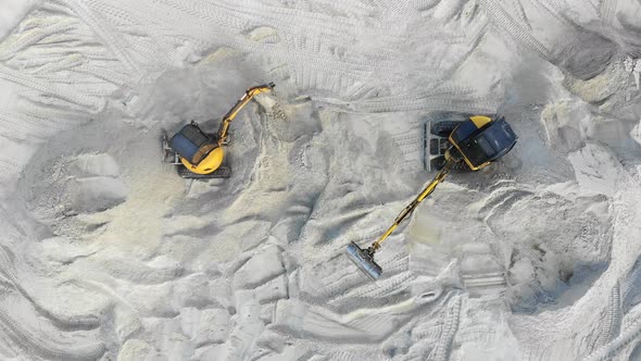 Aerial View, Two Excavators Are Working in a Sand Pit. Extraction of Sand. Work of Two Yellow