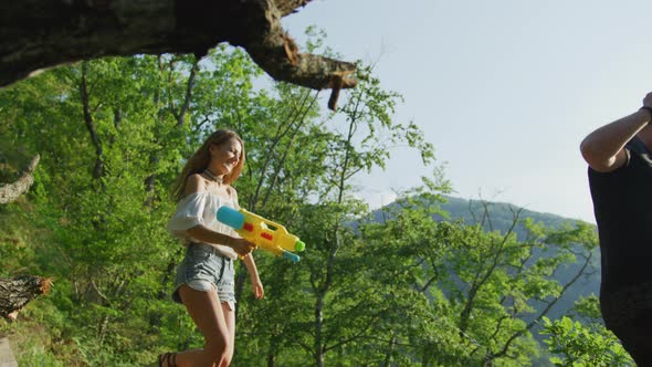 Young couple with a water gun