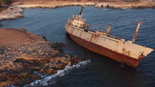 Aerial Of Rusty Shipwreck Close To Shore With Crashing Waves During Sunset 2