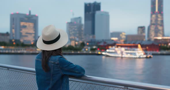 Woman look at the city view in yokohama at night