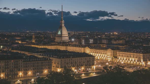 Timelapse day to night over Turin Italy, town wake up, colorful dramatic sky