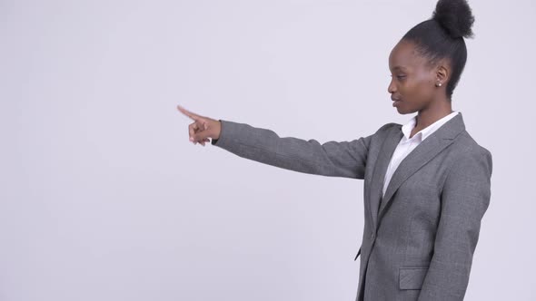 Profile View of Young Happy African Businesswoman Pointing Finger