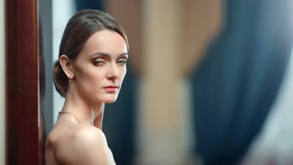 Portrait of Sexy Naked Woman with Evening Makeup Posing in Jewelry