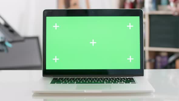 Green Screen on a Laptop Display on a Blured Background