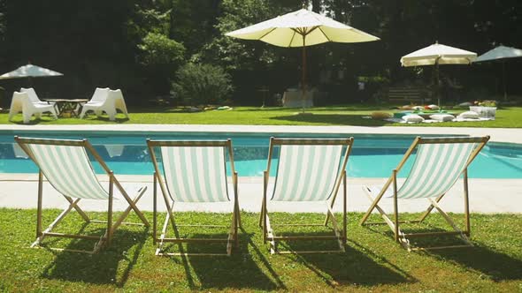 Deckchairs near swimming pool at wedding