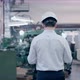 Shot of Professional Factory Worker Wearing Hard Hat Holds Tablet Computer Walking Through Modern - VideoHive Item for Sale