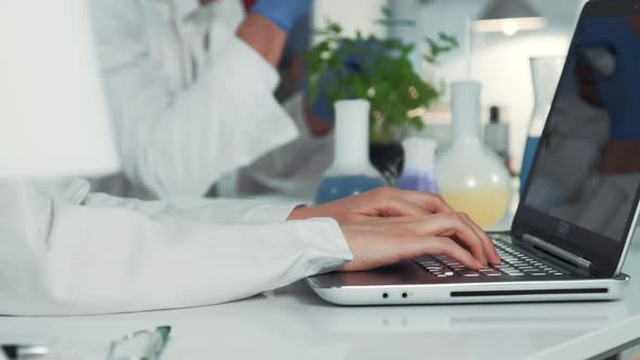 Close-up of Scientist's Hands Using Computer in Chemistry Laboratory