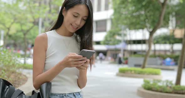 Young Woman working on smart phone in the city 