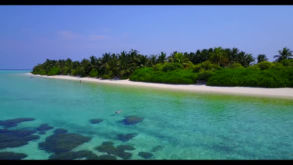 Aerial above sky of idyllic tourist beach break by blue ocean and white sand background of a dayout 