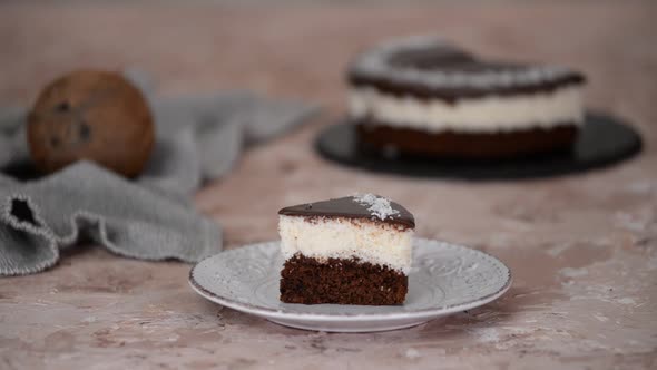 Piece Of Chocolate Coconut Cake On White Plate