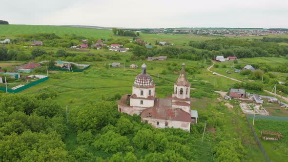 Old Christian Church in the Middle of the Green Field with Some Residential Areas
