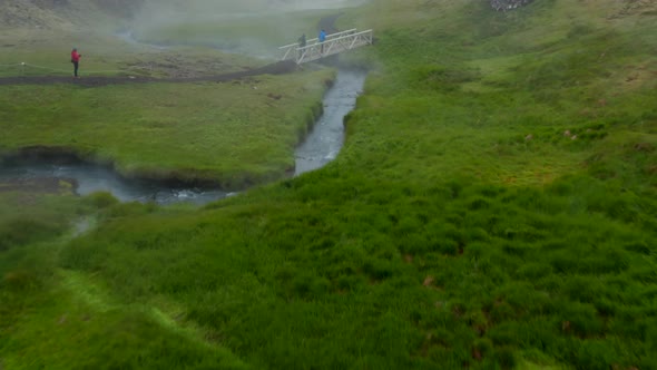 Drone View Tourist Walking Footpath in Reykjadalur Iceland Valley in Foggy Day