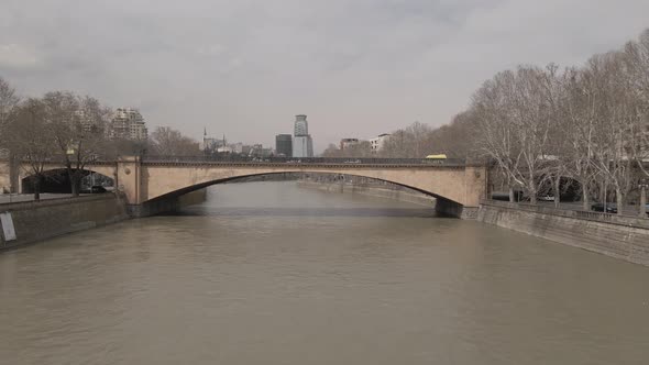 Aerial View of Galaktion Tabidze Bridge over Kura river in the centre of Tbilisi. Georgia 2021 April