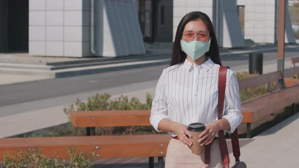 Portrait of Young Asian Woman in Face Mask Outdoors