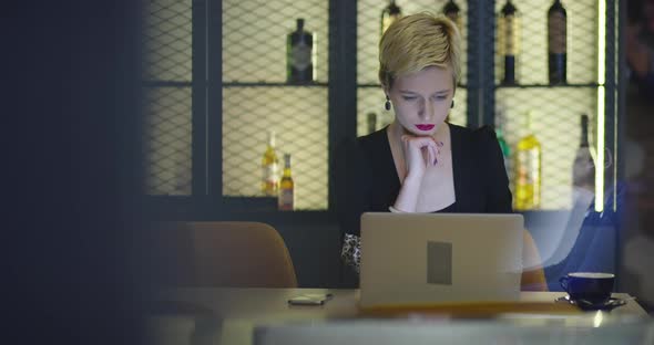 Businesswoman Working On Laptop In Coffee Shop