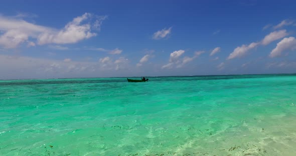 Luxury birds eye clean view of a sandy white paradise beach and aqua blue water background in 4K