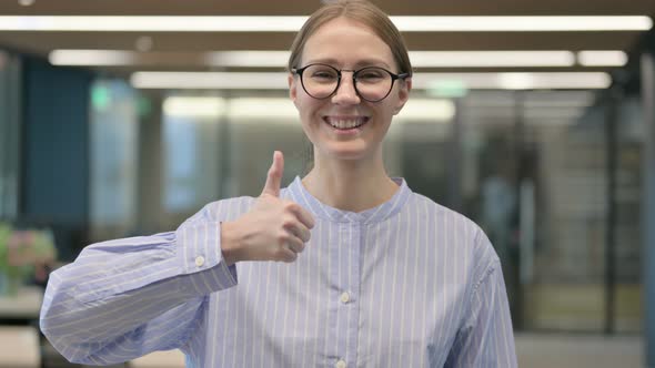 Portrait of Young Woman Showing Thumbs Up Sign