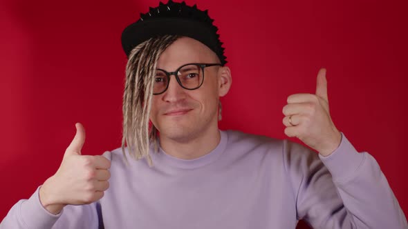 Young Handsome Man in Black Cap Glasses Showing Thumbs Up Looking at Camera