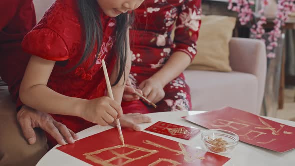 Chinese Family Making Postcards for Lunar New Year