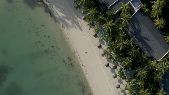 Aerial view of a blonde woman relaxing on the beach, Mauritius. alt